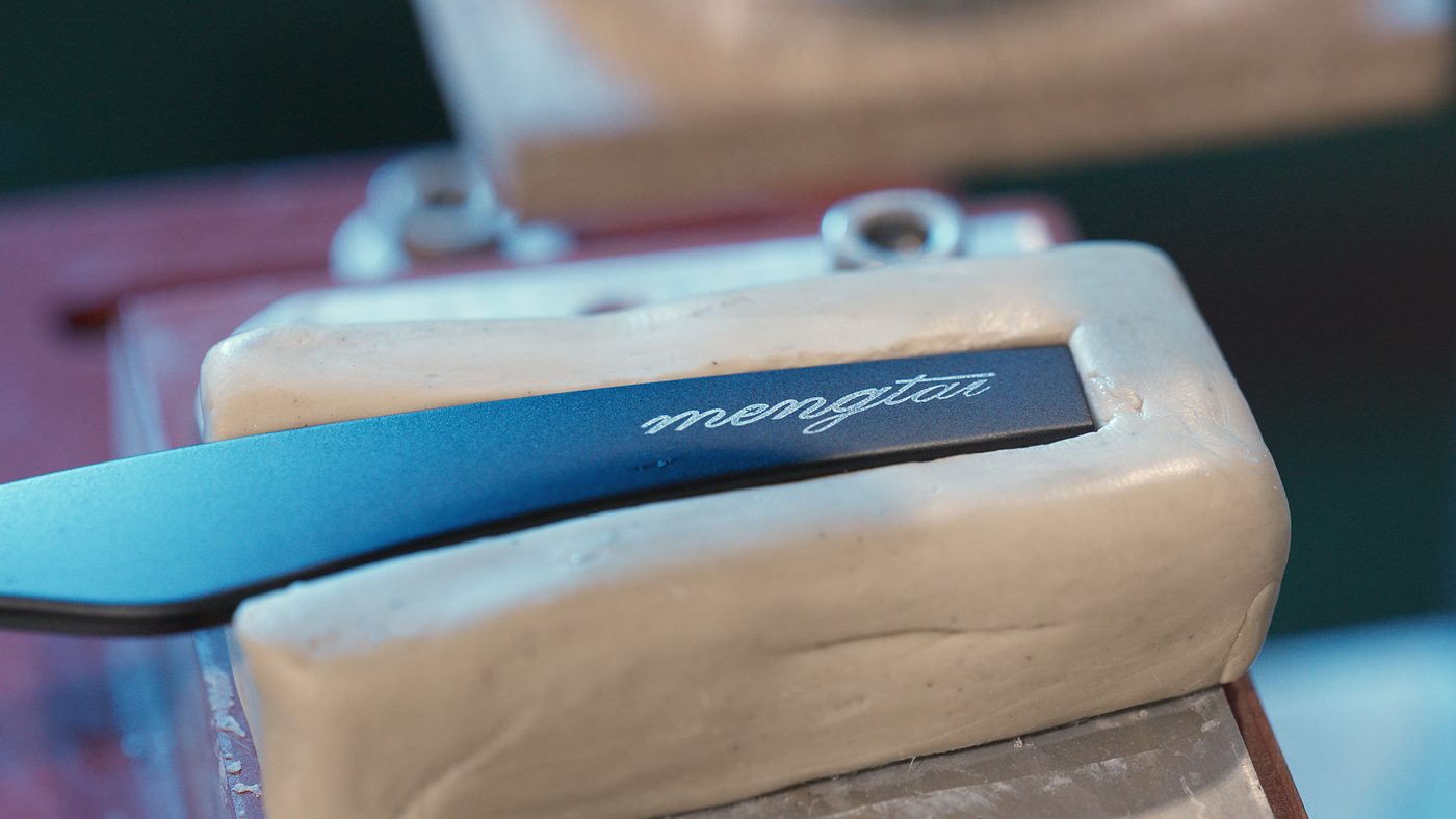 Laser etched brand mark on a mirrored lens